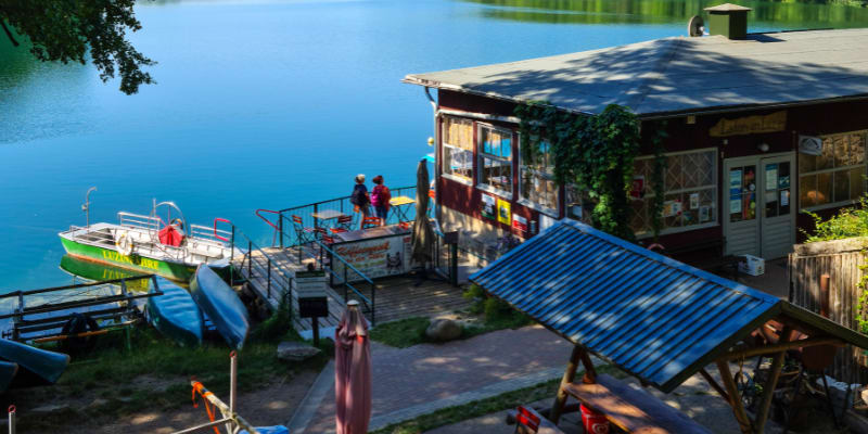 Dock with boats and people in the summer.