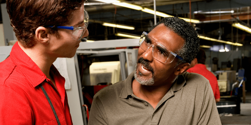 Experienced worker training a new worker.