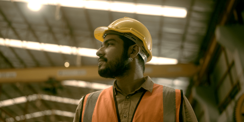 Worker in a vest working in a factory.