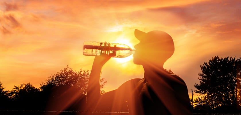 Worker drinking water during heat wave.