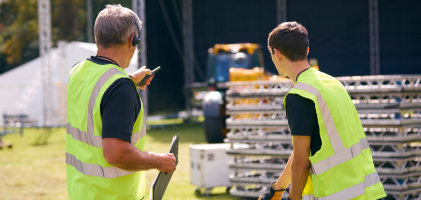 Event Team With Headsets Setting Up Outdoor Stage For Music Festival Or Concert