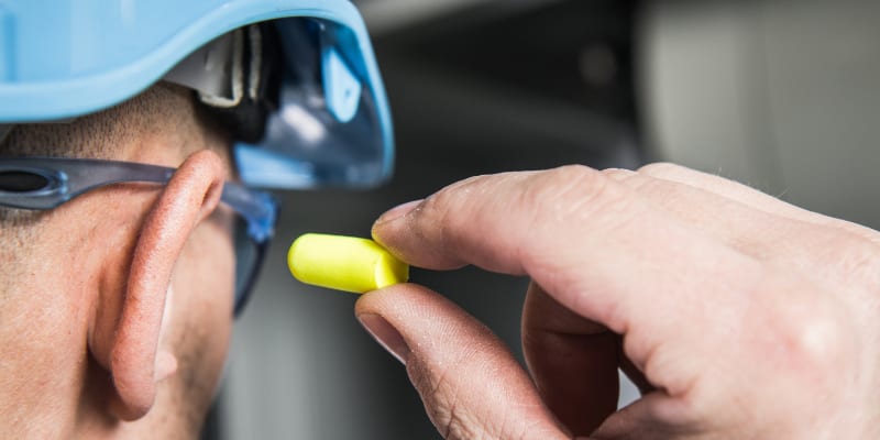 Worker using noise protection.