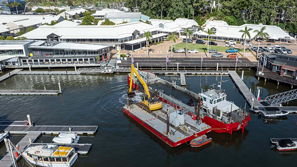 Excavator dredging in marina