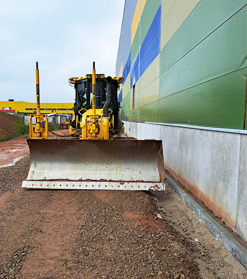 A dozer near a building.