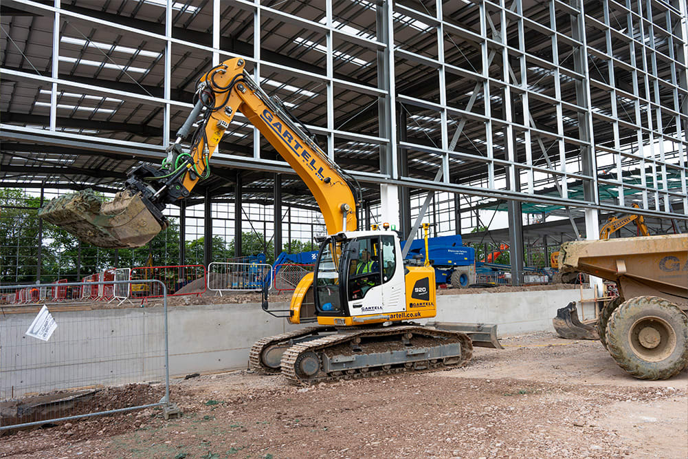 Trimble Earthworks Excavator Near Building