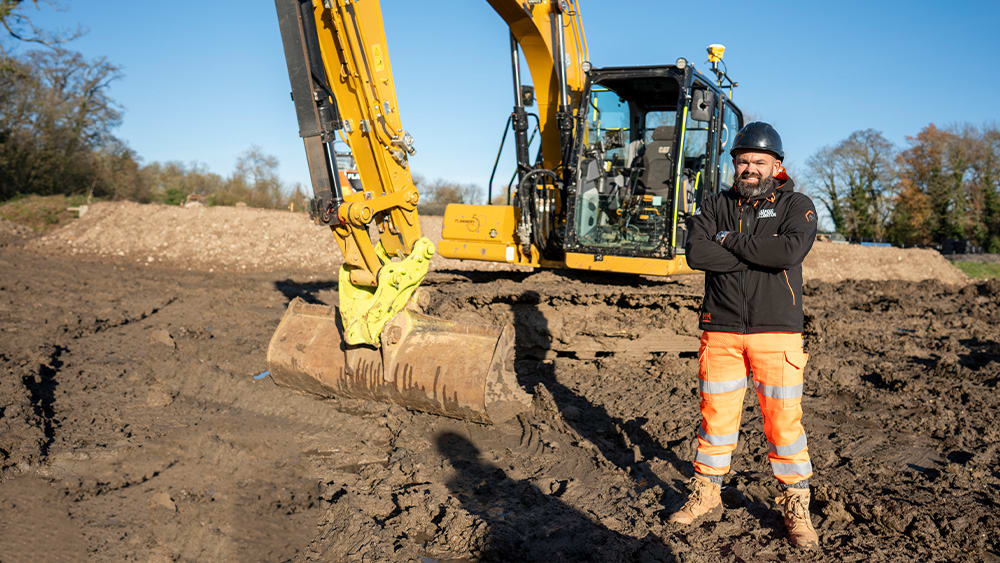 Lloyd Peckham and an excavator with Trimble Earthworks