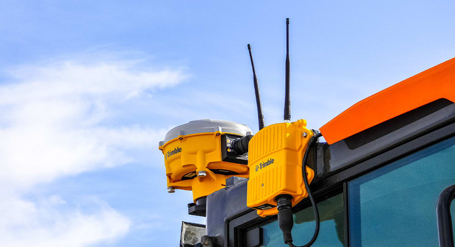 An image of a machine outfitted with Trimble construction technology hardware, which remains up-to-date when purchased on subscription]
