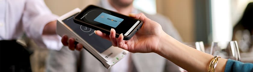 Customer using a digital wallet on their phone to pay