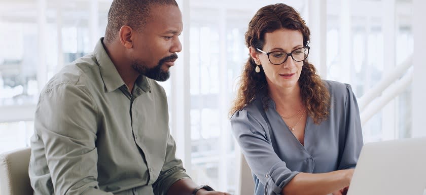 Two professionals collaborating on digital payment solutions for nonprofits.