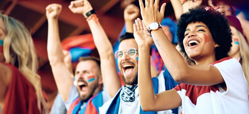 Excited fans celebrating at an event.