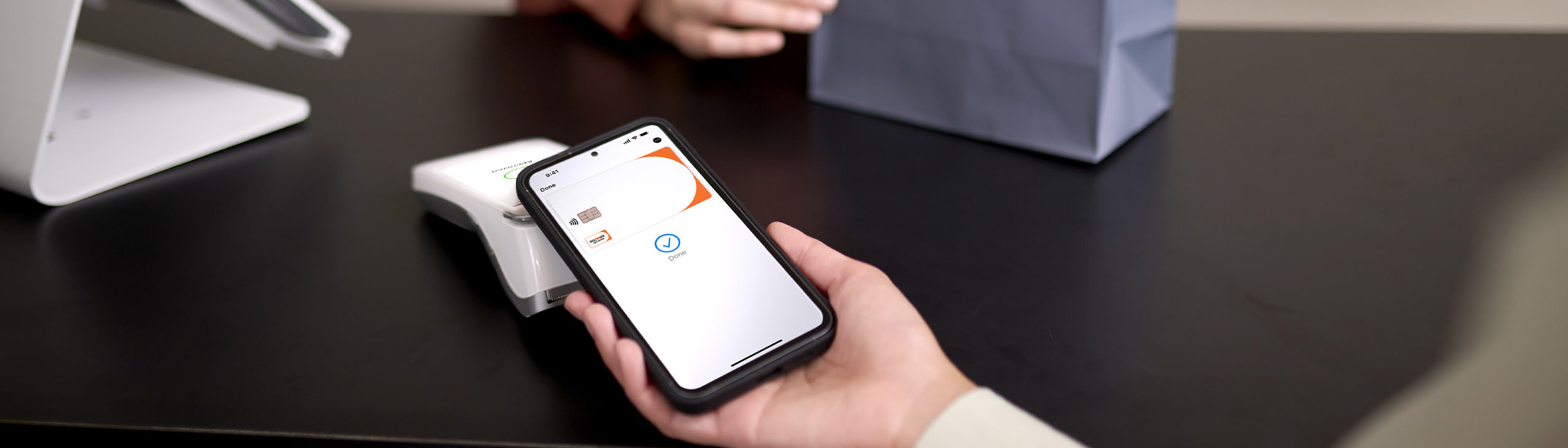 Person paying with Discover card using tap on mobile