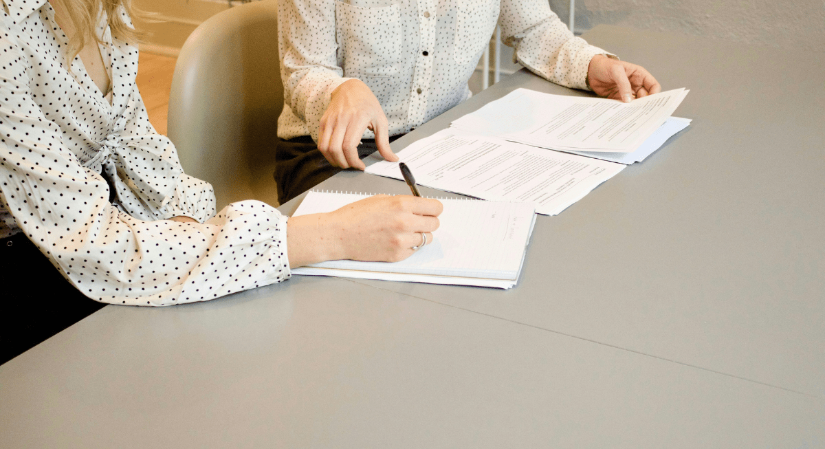 Two women working with documents