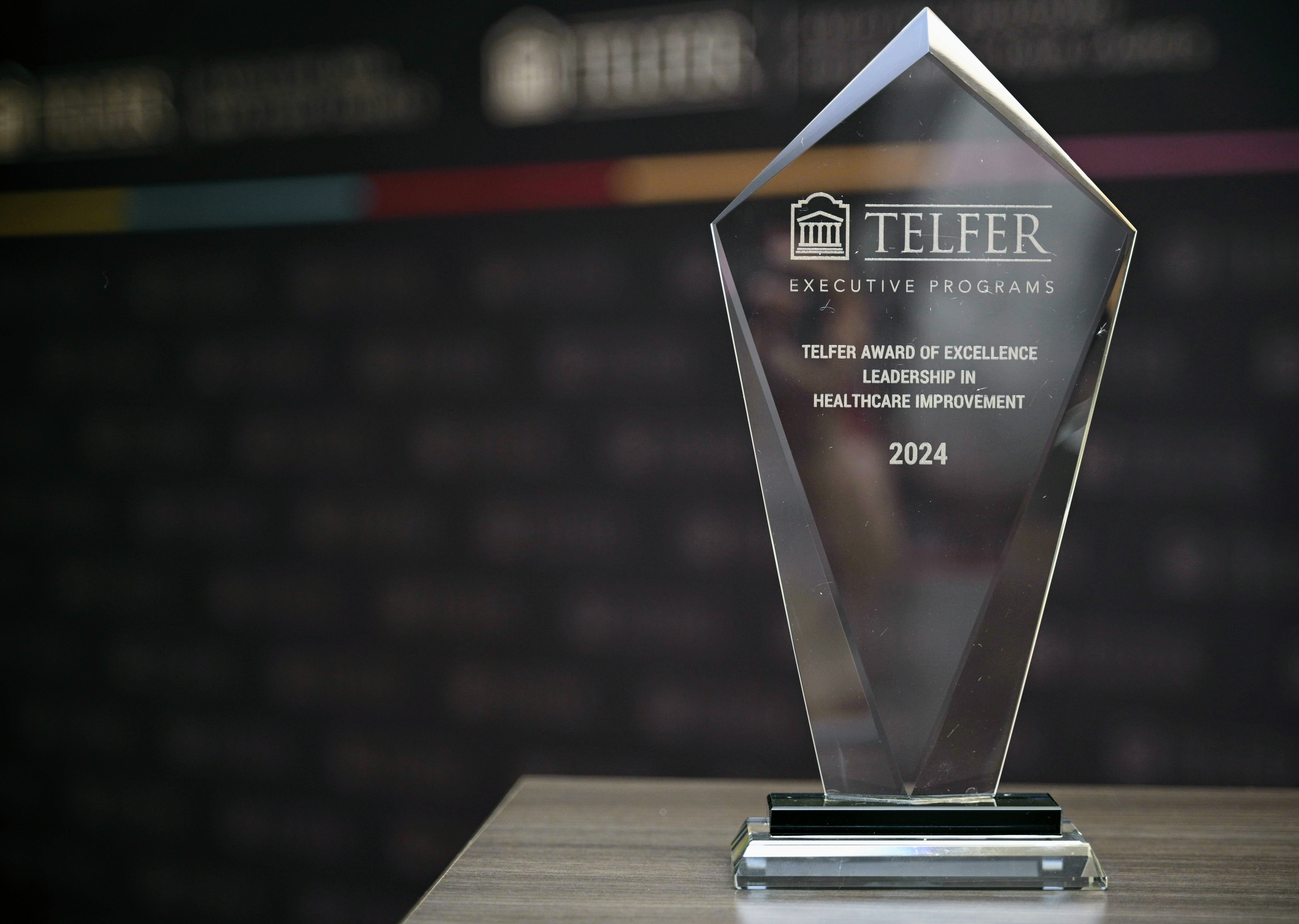 The Telfer Award of Excellence: Leadership in Healthcare Improvement award rests on a table in front of a backdrop at the Telfer Centre for Executive Leadership.