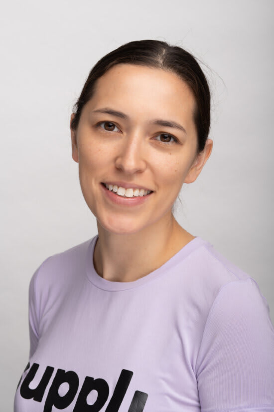 Megan Takeda-Tully headshot wearing a Suppli T-shirt. 