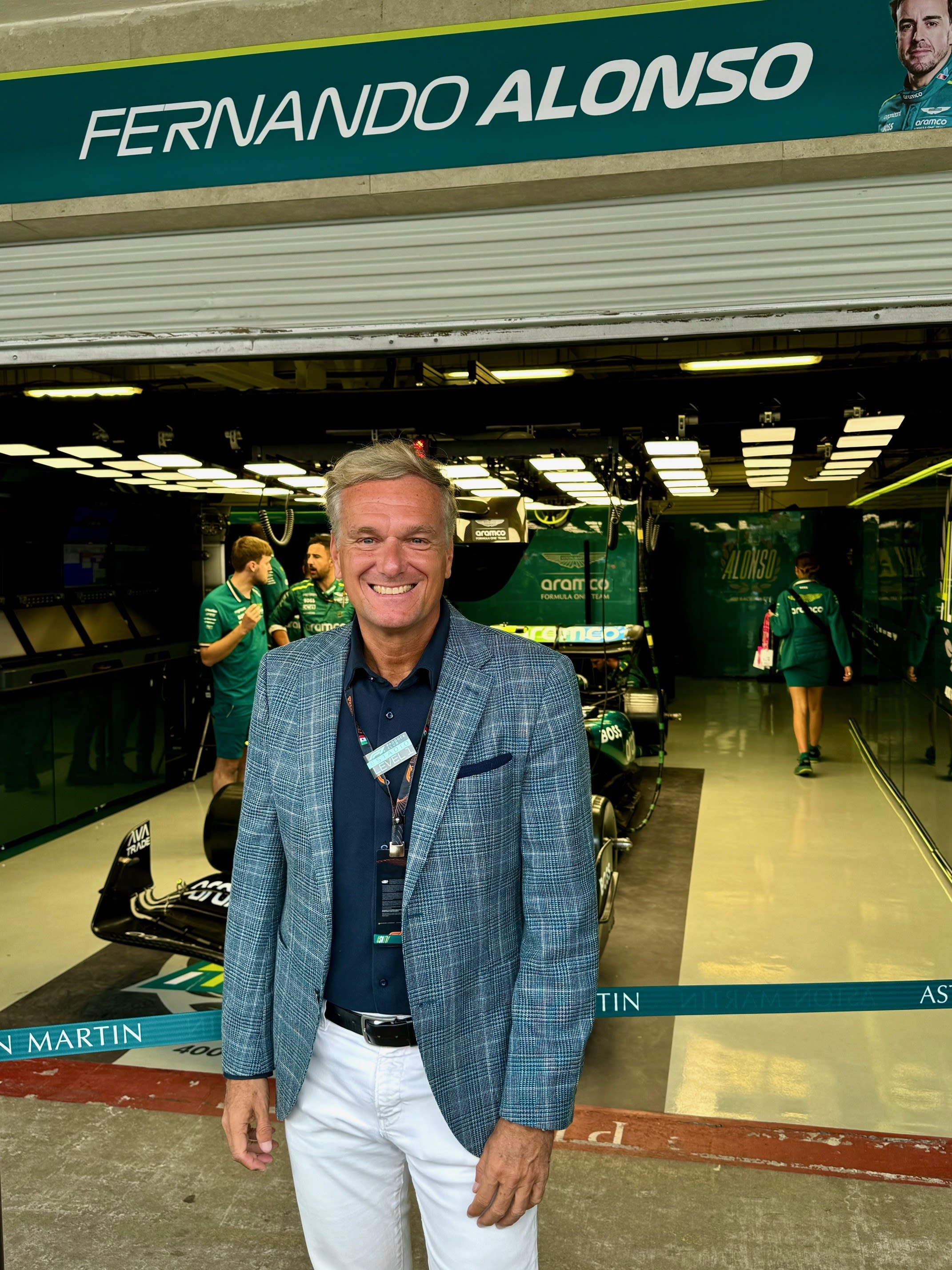 Stephan Born in front of a garage, showcasing a green and white sign above the entrance.
