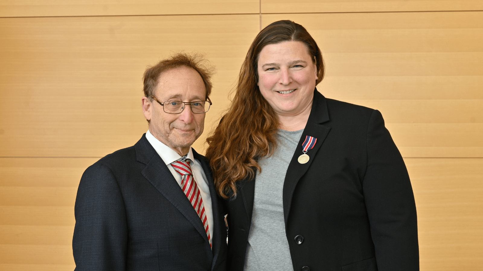 A woman and a man dressed in business attire.