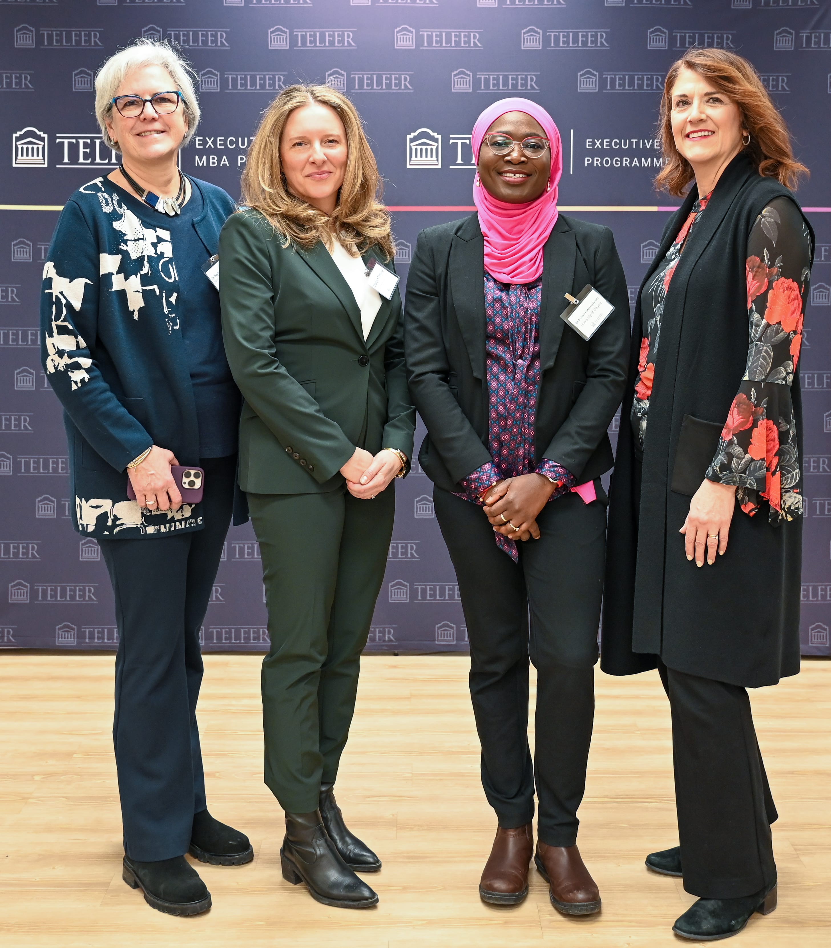 Les panélistes, la Dre Chantal D’Aoust-Bernard, la Dre Guylaine Lefebvre et la Dre Foluso Hafeezat Ishola, et la modératrice, Elizabeth Tanguay, devant la bannière de Telfer au Campus pour cadres de Telfer, le 5 mars 2025.