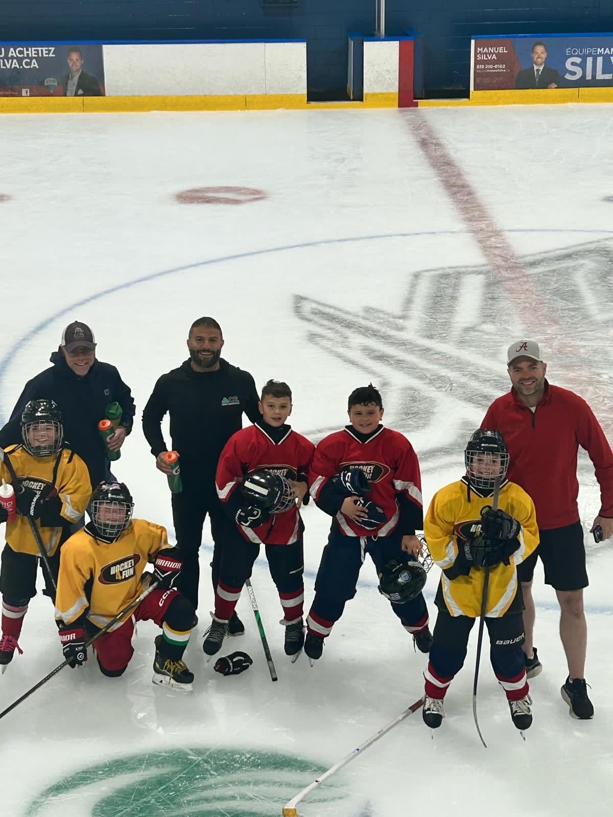 Jason Anbara with a local youth hockey team, supporting young athletes and fostering community engagement.
