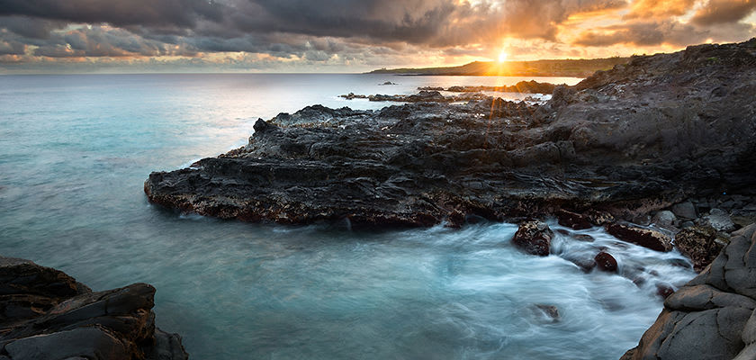 rocky coast line of Maui with sunset