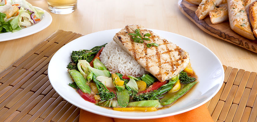 Mahi-mahi mahi mahi on top of rice and vegetables