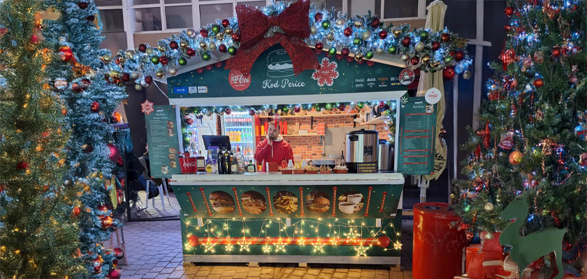 Food and drink stall decorated with Christmas lights at the 2024 EU Advent Festival in Zagreb, Croatia.