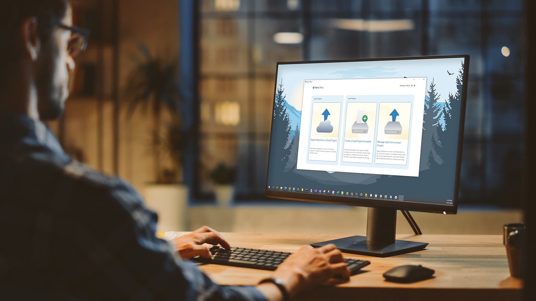 Person sitting at a monitor showing Terra Office Local & Cloud project screen