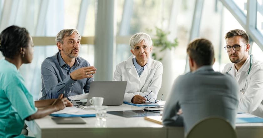 Healthcare executives sitting around the table in a conference room