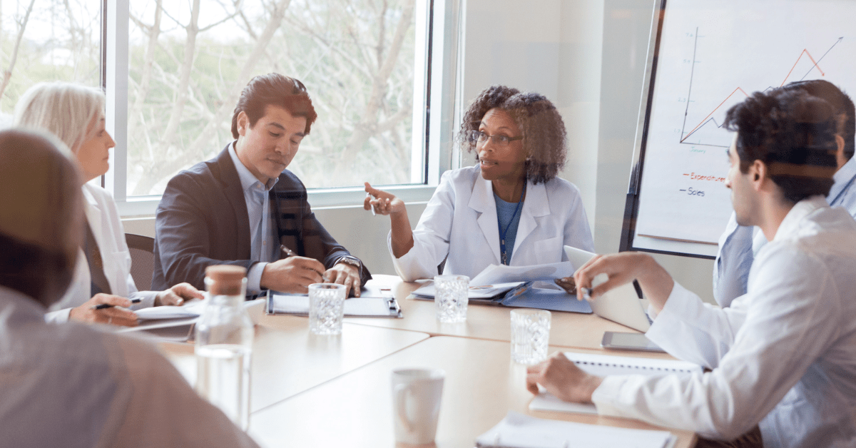 Payers gathered around a table discussing plans