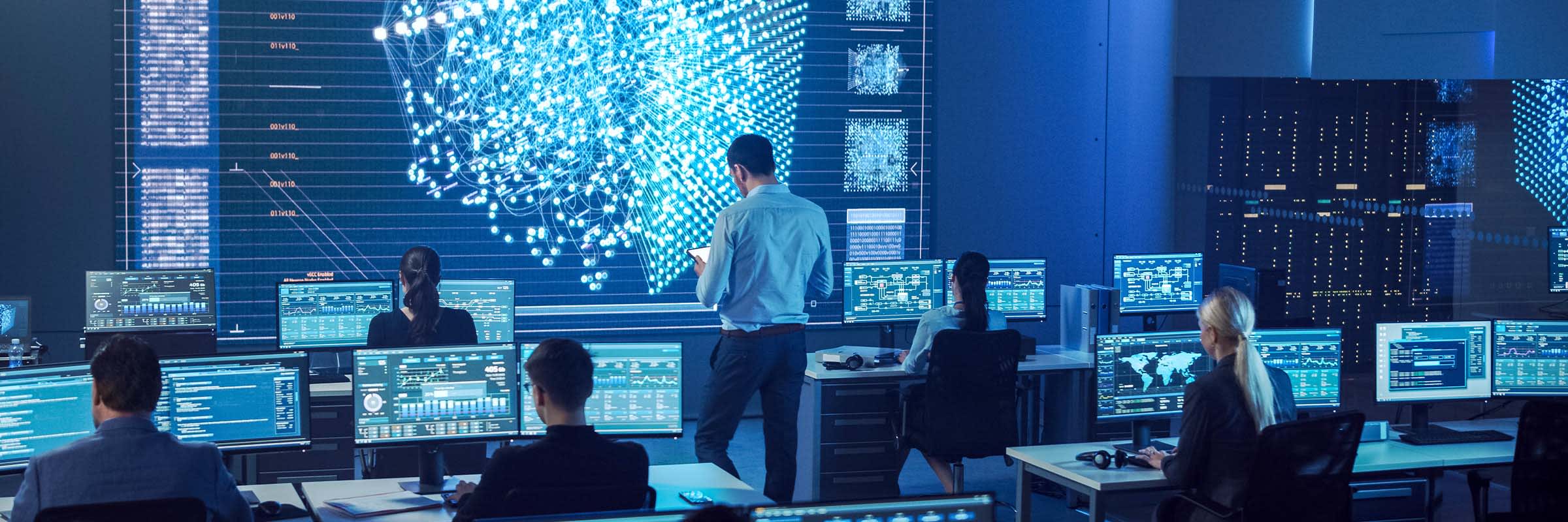 Bell employees gather in data centre to analyze DDoS security trends and data.