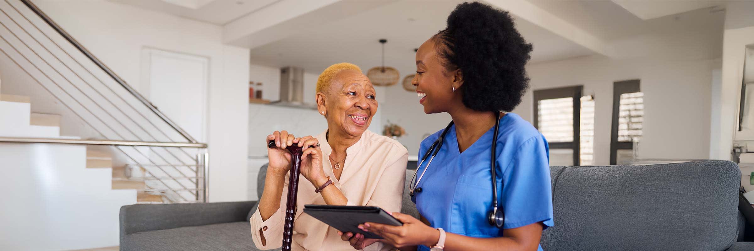 Care practitioner visits a patient with a walking stick at remote home visit 
