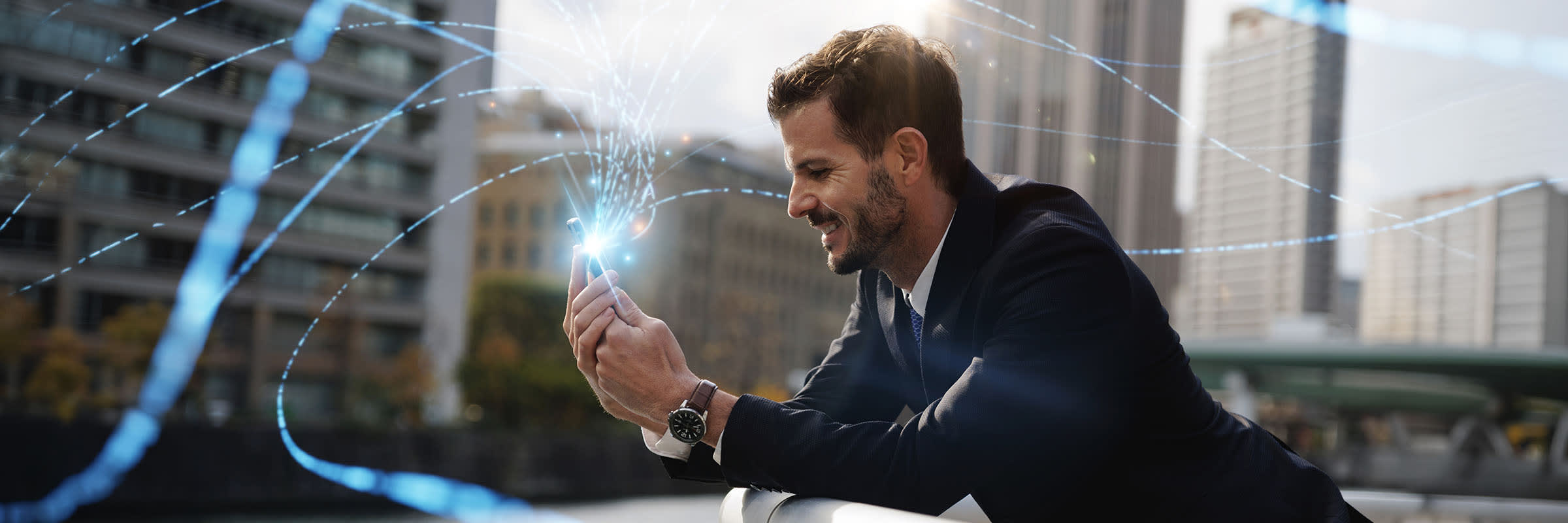 A businessman is using a smartphone on Bell's mobile network.