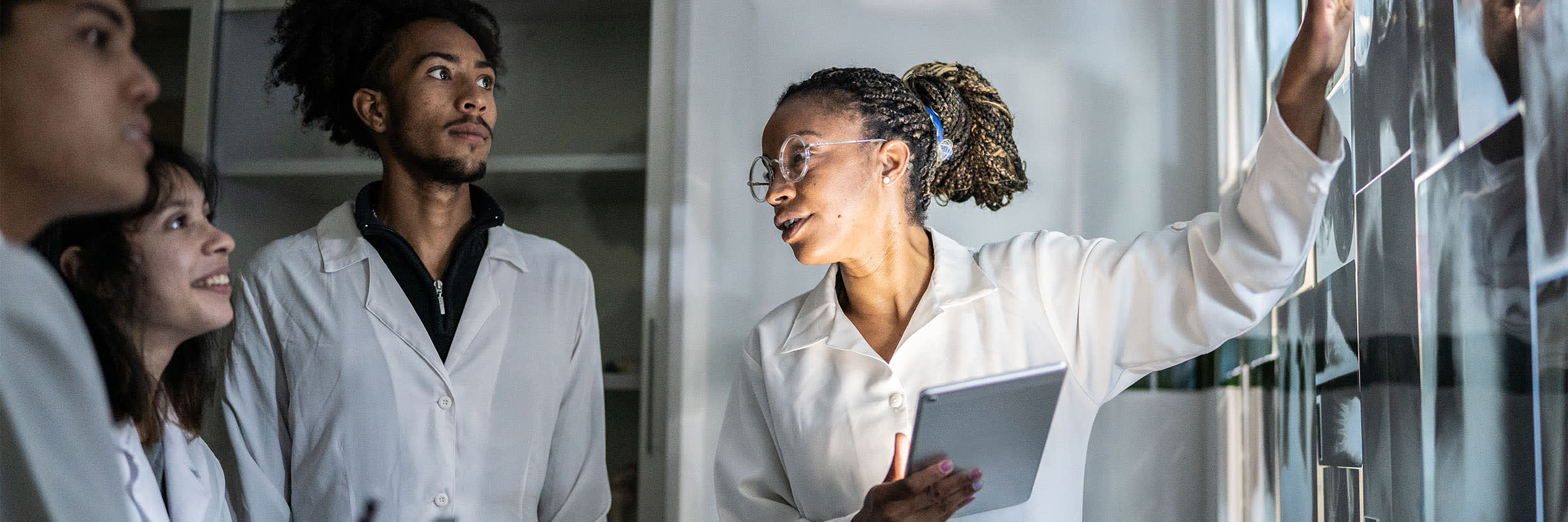Researchers and students at Thompson Rivers University collaborate, reviewing medical imaging to advance AI-driven healthcare solutions.