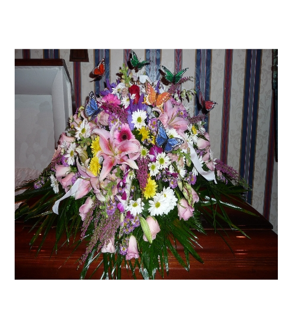 MIXED FLOWER CASKET SPRAY WITH BUTTERFLY ACCENTS