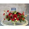 A Holly Jolly Centrepiece - Standard. An arrangement by Say It With Flowers.