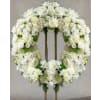 Pure White Wreath - Premium. An arrangement by Geni's Florist and Gifts.
