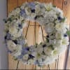 SOFT LIGTH BLUE WREATH - Deluxe. An arrangement by Geni's Florist and Gifts.