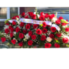 Red Rose Tribute Casket Spray - Standard. An arrangement by Tom's Florist.