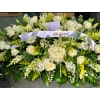 Beloved White Garden Casket Spray - Premium. An arrangement by Tom's Florist.