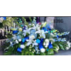Blue and white Serenity, Casket Spray - Standard. An arrangement by Tom's Florist.