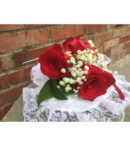 LID CORSAGE. An arrangement by Metcalfe Florist and Pleasant View Greenhouses.