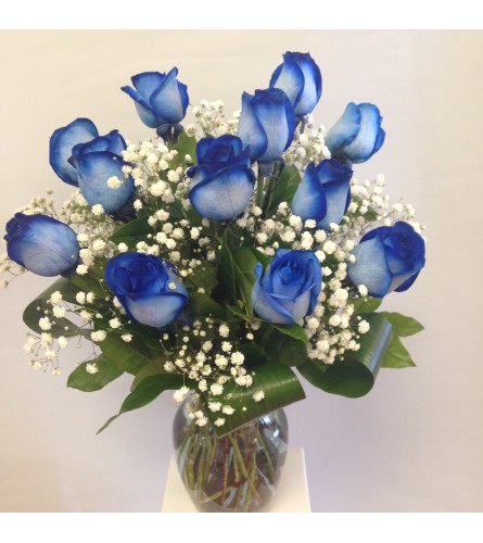Blue Roses with baby's breath. An arrangement by April Showers Floral Designs.