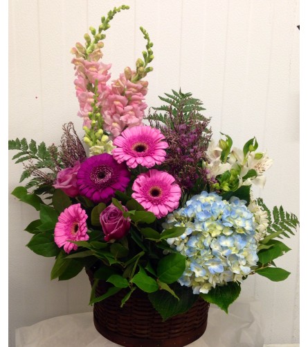whispering basket. An arrangement by April Showers Floral Designs.