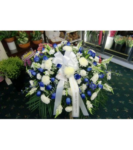 blue and white casket cover with blue roses