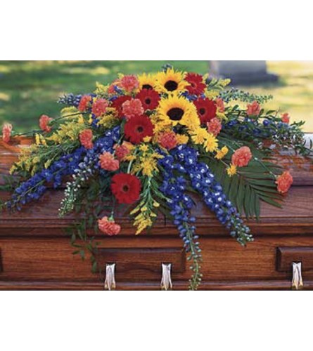 A Tranquil Peace Casket Spray - Standard. An arrangement by Seasons Change Designs.