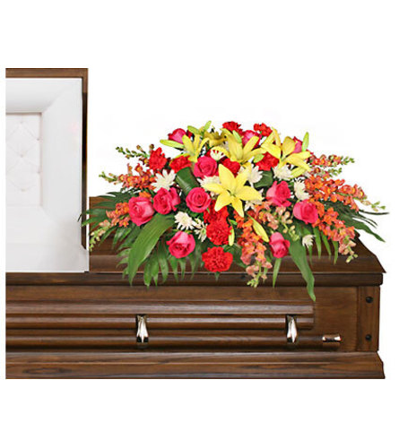 IN LOVING MEMORY CASKET SPRAY. An arrangement by Elegant Florist.