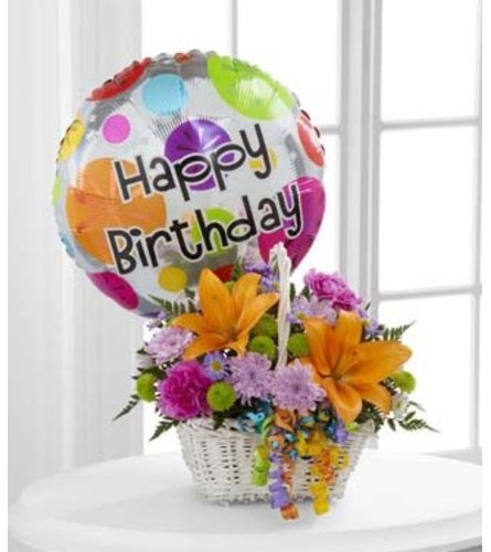 The FTD Happy Blooms Basket Arrangement. An arrangement by Balloon Bouquets Plus.