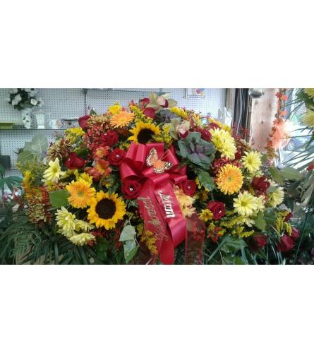 autumn casket spray. An arrangement by Howard Beach Florist.