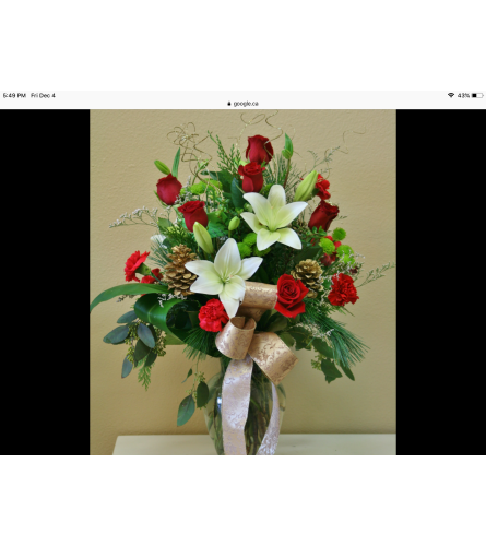 Charismatic Christmas vase arrangement. An arrangement by Kitchener Ontario Florist.