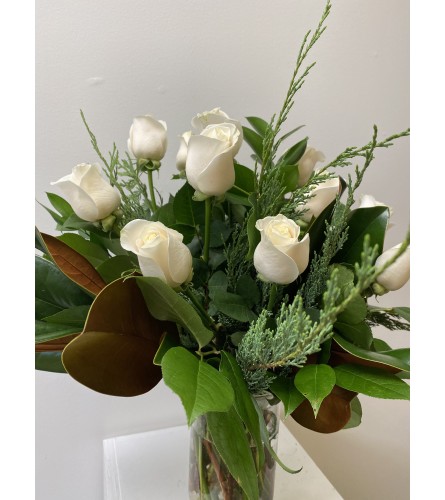 12 white roses arranged for Christmas. An arrangement by Flower Trends Florists.