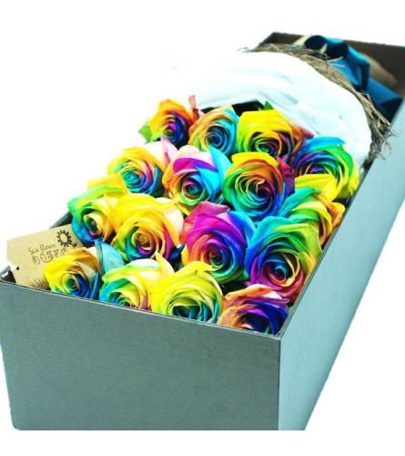 Dozen Rainbow Roses Boxed. An arrangement by Wasaga Flowers.